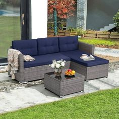 an outdoor living room with blue couches and coffee table