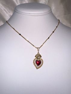 A beautiful 14k gold and red enamel sacred heart necklace on a 14k gold filled curb chain. Featuring cubic zirconia pave detailing on the pendant. Chain length: 17.5 Inch Spiritual Red Necklace With Heart Charm, Gold Plated Heart Beads Pendant Jewelry, Red Heart Charm Fine Jewelry, Gold Plated Heart Pendant Jewelry, 14k Gold Filled Pendant For Valentine's Day, 14k Gold Filled Pendant Jewelry For Valentine's Day, Red Fine Jewelry With Heart Charm, Red Jewels Jewelry For Valentine's Day, Red Jeweled Jewelry For Valentine's Day