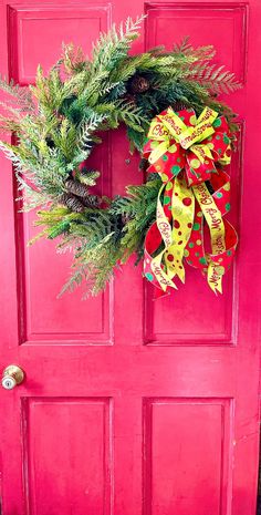 a red door with a wreath on it