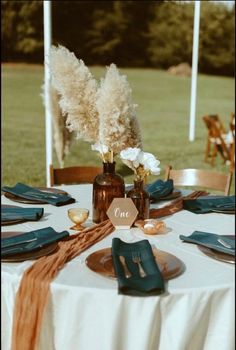 the table is set with blue napkins and place settings for two people to sit at