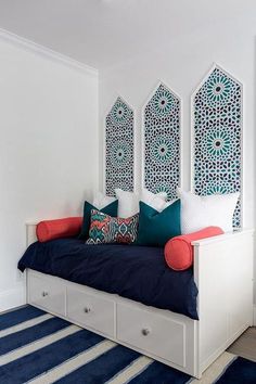 a bedroom with blue and white decor on the walls