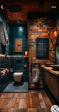 a bathroom with wooden floors and blue tile on the walls, along with a brick wall