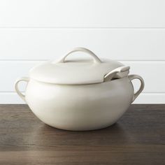 a large white pot sitting on top of a wooden table