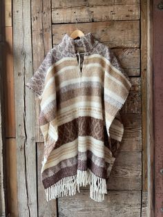 Brown wool poncho Alpaca/lambswool mix poncho Beige wool poncho very warm and breathable Ethno style Blanket poncho with fringes alpaca wool One size fits fashionably for most everyone, short or tall, big or small. This piece is versatile for both Men's & Women's outdoor fashion, and can be used insider in cooler winter weather to keep warm while reading on the couch. CARE: Hand-wash and hang to dry, light iron if needed, or dry clean. MEASURES: Length at the front of the neckline to the bottom Bohemian Alpaca Shawl For Fall, Handwoven Alpaca Poncho For Fall, Fall Handwoven Alpaca Poncho, Bohemian Alpaca Cape For Fall, Brown One Size Poncho With Fringe, One Size Brown Fringe Poncho, Brown Fringe One Size Poncho, Traditional Alpaca Poncho For Fall, Handwoven Wool Poncho For Fall