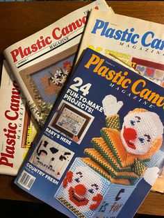 four plastic canvass are on top of each other, and there is a magazine cover in the shape of a clown