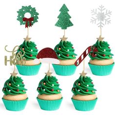 cupcakes decorated with green frosting and christmas decorations are arranged in front of a white background