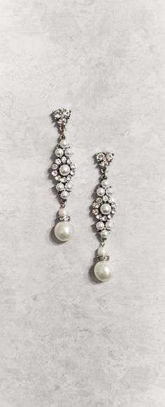 Elegant Vintage style Bridal Earrings. Made with clear crystals and crystal white pearls. They are about 21/4 inches long. Sparkling deco drama that makes a statement for brides or black tie affairs. Bright withe pearls and crystal against antique silver metal gives these earrings a beautiful pup out look. If you have any questions feel free to contact me via Etsy convo. Happy shopping with Simply Chic. Cheap Silver Vintage Chandelier Earrings, Silver Jeweled Pearl Earrings, White Chandelier Earrings With Sparkling Stones, Elegant White Jeweled Bridal Earrings, Jeweled Silver Pearl Drop Earrings, Elegant White Chandelier Earrings With Rhinestones, Crystal Pearl Drop Dangle Bridal Earrings, Pearl White Pearl Drop Earrings With Crystal, White Sparkling Chandelier Dangle Earrings