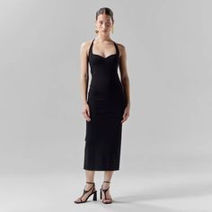 This classic, midi-length fitted black dress has a modest leg slit for elegance and ease of movement. Made from luxury heavyweight Italian stretch viscose, it's designed to hug and  accentuate curves while ensuring a comfortable and flattering fit.  With adjustable self-tie shoulder straps, wear as a sweetheart halter or an asymmetric neckline, catering to your style and mood of the day. Go braless if you desire.  Perfect for any occasion, dress it up with statement gold earrings, strappy black Statement Gold Earrings, Mood Of The Day, Asymmetric Neckline, Black Halter Dress, Black Strappy Heels, June Birthstone Jewelry, Gold Statement Earrings, Sweetheart Dress, Zodiac Jewelry