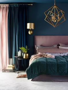 a bedroom with blue walls, gold accents and a pink headboard on the bed