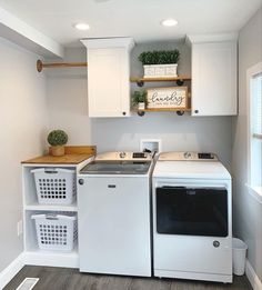 a white washer and dryer in a small room