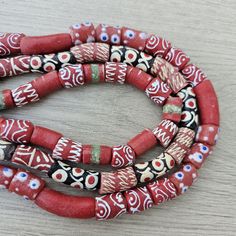 three red and black beads are on a table