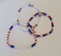 These red white and blue bracelets are so cute, and perfect for the season!  Items are handmade with love, so each piece is unique and may contain small imperfections and differences. We think this makes them even more beautiful! 4th Of July Bracelets Diy, Patriotic Blue Bracelets For Beach, 4th Of July White Beaded Bracelets Gift, Patriotic Blue Friendship Bracelets As Gift, White Beaded Bracelets For 4th Of July Gift, Patriotic White Friendship Bracelets Gift, Patriotic White Friendship Bracelets As Gift, Patriotic Red Beaded Bracelets As Gift, Blue Stretch Bracelet For 4th Of July Gift