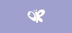 a white butterfly on a purple background with the letter k in it's center