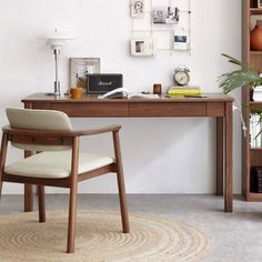 a wooden desk with a chair and bookshelf in the corner next to it