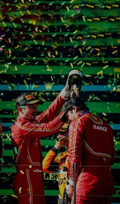 two men standing next to each other with confetti in front of their faces