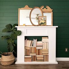 a white fireplace with books on it and a mirror