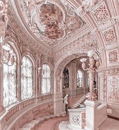 an ornately decorated room with red and white decor on the walls, stairs and windows