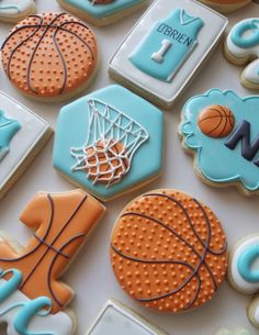 cookies decorated to look like basketballs, basketball hoop and other sports related items are arranged on a table