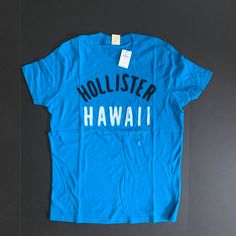 Hollister Embroidered Crew Neck T-Shirt Brand New With Tags, Never Worn Casual Short Sleeve Tops With Embroidered Graphics, Summer Cotton Shirt With Logo Print, Blue Tops With Embroidered Logo For Spring, Casual Blue Tops With Embroidered Logo, Relaxed Fit Top With Embroidered Logo For Summer, Summer Tops With Relaxed Fit And Embroidered Logo, Casual Blue Tops With Text Print, Blue Casual Top With Embroidered Logo, Casual Summer Shirt With Embroidered Graphics