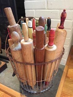 a wire basket filled with different types of wooden utensils