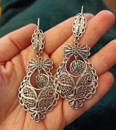 Beautiful Silver color metal MAXI Portuguese Princess Style Earrings. They are made with ZAMAK alloy. Super cute gift idea for girls and women. A perfect gift idea for your Girlfriend, Mother or other special lady in your life that you love and care, without breaking the bank. They are brand new, with Portuguese Filigree inspired details. Hook Style with silicone clasp, preventing accidental loss. Will be sent with Organza Pouch or Gift Box, as you prefer, or in a randomly assigned matter. You c Filigree Chandelier Earrings As Gift, Metal Filigree Chandelier Earrings, Silver Filigree Dangle Flower Earrings, Filigree Metal Earrings For Party, Metal Filigree Earrings For Party, Silver Filigree Chandelier Earrings As Gift, Silver Filigree Chandelier Earrings For Gift, Handmade Silver Chandelier Earrings For Gift, Handmade Silver Chandelier Earrings As Gift