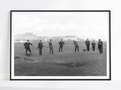 a group of men standing on top of a grass covered field next to each other