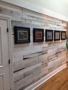 the wall is made out of wood planks and has pictures hanging on it's sides