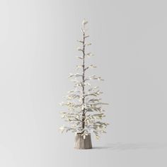 a small white christmas tree with lights on it