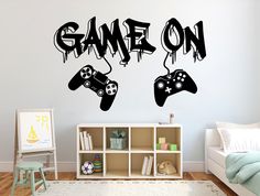 two video game controllers with the word game on painted on it's wall in a child's room