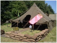 there is a tent that has been set up in the grass for people to use