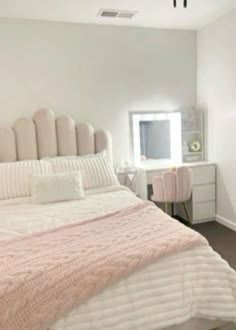 a bedroom with a bed, desk and mirror