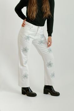 This is a 100% Cotton, Jean. It is embroidered with our signature brand logo flower. It fits mid-waist with wide-leg at the bottom of the jean. It can be styled in many ways and weather. Mix and match with some sneakers, boots, or heels. Trendy Cotton Flare Jeans For Winter, Trendy Winter Flare Jeans In Cotton, Casual Embroidered Cotton Flare Jeans, Casual Embroidered Winter Bottoms, Fall Floral Embroidered Wide Leg Jeans, Mid-rise Cotton Flare Jeans For Winter, Winter Wide Leg Cotton Flare Jeans, Winter Mid-rise Cotton Flare Jeans, Trendy Embroidered Relaxed Fit Jeans