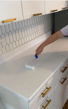 a person using a brush to clean a counter top