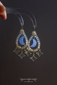 "---- Welcome to CiaoQiao Shop ----- Discover the whimsical charm of our Floral Starburst Teardrop Earrings from the Enchanted Garden Collection. These stunning pieces feature an elegant teardrop silhouette adorned with delicate star-shaped crystals and accented by serene blue gemstones. The centerpiece is a beautifully crafted floral bead, bringing a touch of nature-inspired grace to your ensemble. The golden wire wrapping adds a vintage feel, perfect for both daytime charm and evening elegance Whimsical Earrings, Shaped Crystals, Princeton Nj, Enchanted Garden, Blue Gemstones, Floral Earrings, Pure Gold, Star Shape, Jewelry Plate