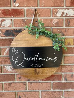 a wooden sign hanging on the side of a brick wall that says, the quainte's