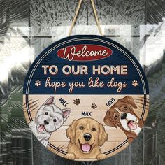 a welcome sign with three dogs hanging from it's front glass door and the words welcome to our home, hope you like dogs