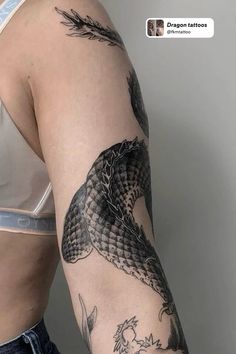 a woman's arm with a snake tattoo on it