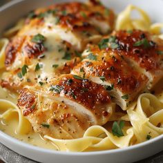 a white bowl filled with chicken and pasta