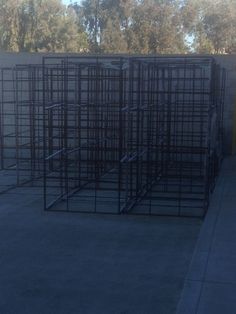 several large metal structures sitting in the middle of a parking lot