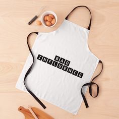 an apron with the words bad science on it next to eggs and utensils