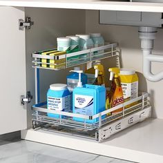 a kitchen cabinet filled with lots of cleaning products