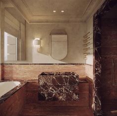 a bath room with a tub and a mirror on the wall next to a sink