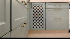 a kitchen with gray cabinets and white counter tops