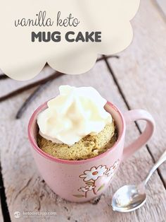 there is a cupcake with whipped cream in it and the words vanilla keto mug cake above it