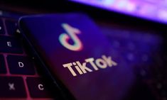 the tiktok logo is displayed on a laptop keyboard