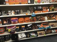 a store shelf filled with lots of halloween decorations and pumpkins on it's shelves