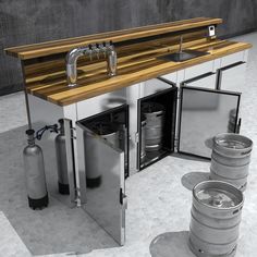 an industrial kitchen with stainless steel appliances and wooden counter tops, including two kegs