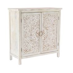 an ornate white cabinet with carvings on the front and sides, against a white background