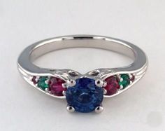 a blue ring with three different colored stones