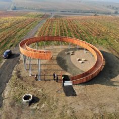 two people standing in front of a circular structure